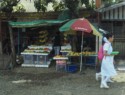 Students walk by a fruit stand